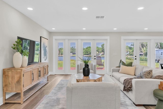 18102 Spencer Rd, Odessa, FL 33556 - living area with french doors, recessed lighting, healthy amount of natural light, and light wood-style floors