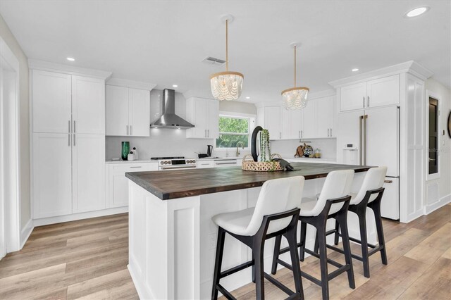 18102 Spencer Rd, Odessa, FL 33556 - kitchen featuring wall chimney exhaust hood, white appliances, butcher block countertops, recessed lighting, and white cabinetry