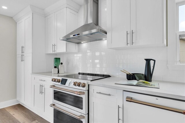 18102 Spencer Rd, Odessa, FL 33556 - kitchen with wall chimney exhaust hood, white electric range, light countertops, white cabinets, and backsplash