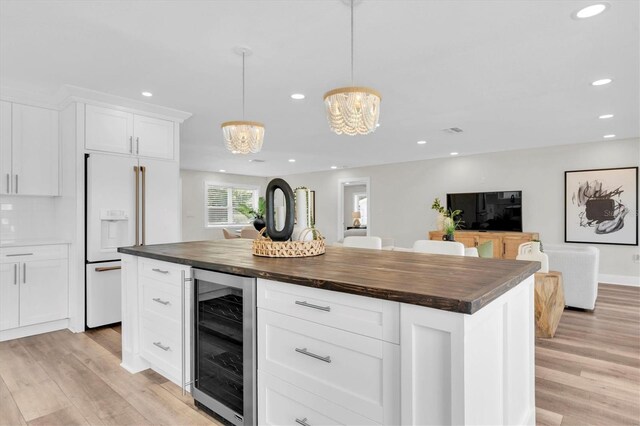 18102 Spencer Rd, Odessa, FL 33556 - kitchen with wine cooler, white built in refrigerator, wooden counters, a chandelier, and recessed lighting