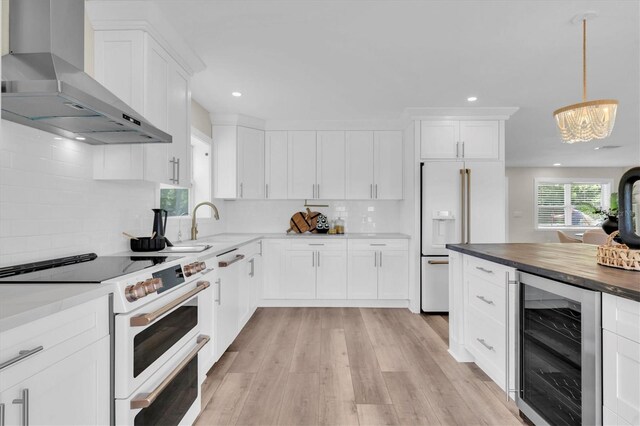 18102 Spencer Rd, Odessa, FL 33556 - kitchen featuring wine cooler, wall chimney range hood, white appliances, decorative backsplash, and white cabinets
