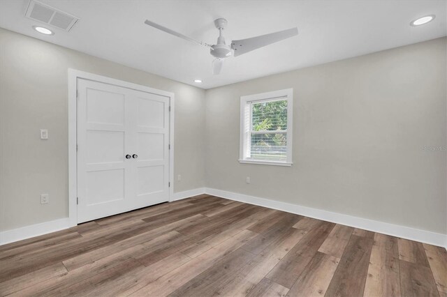 18102 Spencer Rd, Odessa, FL 33556 - unfurnished bedroom with wood finished floors, baseboards, ceiling fan, recessed lighting, and a closet