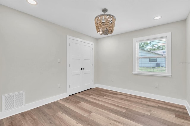 18102 Spencer Rd, Odessa, FL 33556 - unfurnished room with a chandelier, light wood-style flooring, baseboards, and recessed lighting