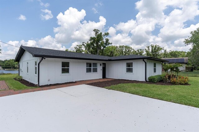 18102 Spencer Rd, Odessa, FL 33556 - view of front facade featuring a front yard and board and batten siding