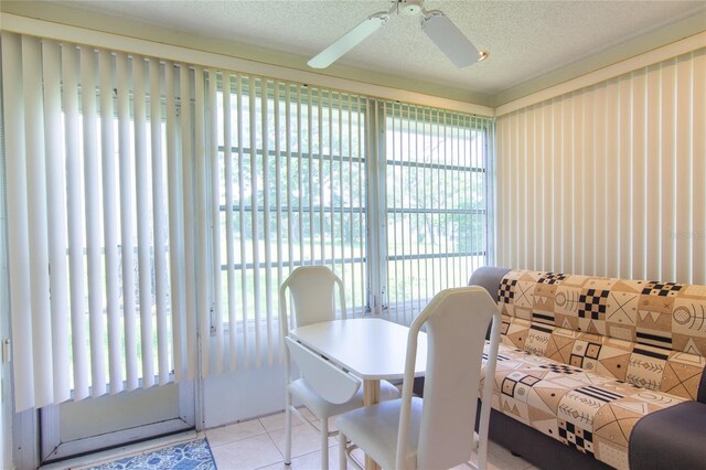 12511 Dearborn Dr, Hudson, FL 34667 - dining area with healthy amount of natural light, tile patterned flooring, ceiling fan, and a textured ceiling
