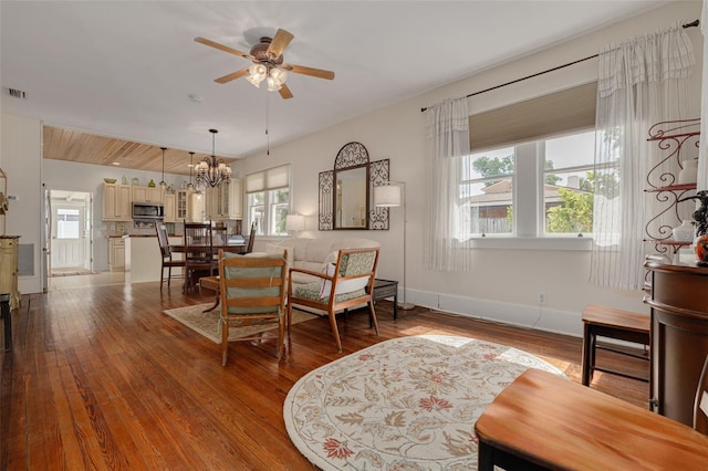 6207 Main St, New Port Richey, FL 34653 - dining space featuring ceiling fan, hardwood / wood-style floors, a chandelier, and baseboards