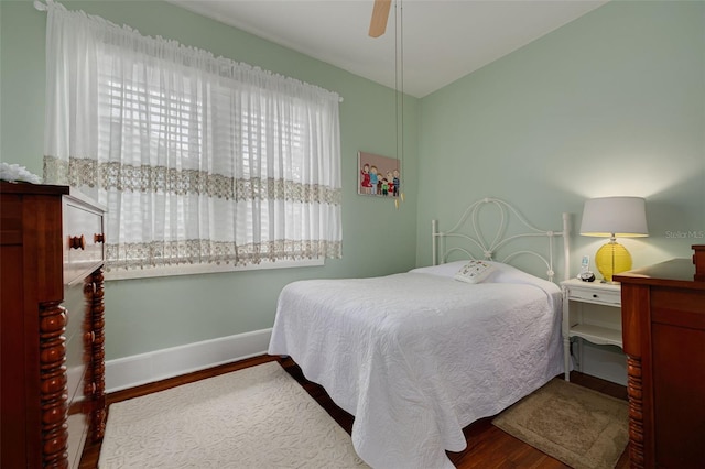 6207 Main St, New Port Richey, FL 34653 - bedroom with wood finished floors, baseboards, and ceiling fan
