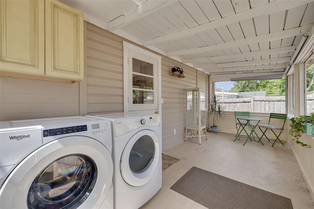 6207 Main St, New Port Richey, FL 34653 - laundry room featuring washing machine and dryer, wood walls, and cabinet space