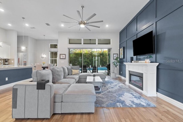 16697 Courtyard Loop, Land O Lakes, FL 34638 - living area with a ceiling fan, recessed lighting, light wood-style flooring, and a glass covered fireplace