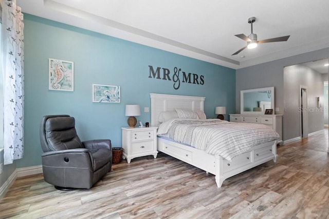 16697 Courtyard Loop, Land O Lakes, FL 34638 - bedroom featuring wood finished floors, a raised ceiling, and ceiling fan