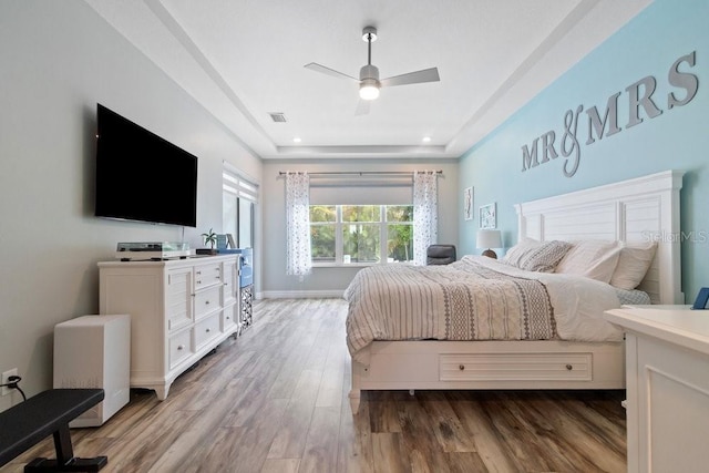 16697 Courtyard Loop, Land O Lakes, FL 34638 - bedroom featuring wood finished floors, recessed lighting, ceiling fan, and a raised ceiling