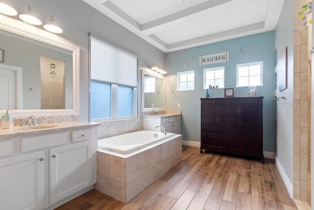 16697 Courtyard Loop, Land O Lakes, FL 34638 - bathroom featuring two vanities, wood finished floors, a bath, and beamed ceiling
