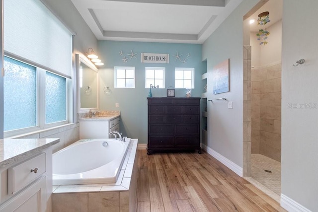 16697 Courtyard Loop, Land O Lakes, FL 34638 - bathroom with a garden tub, vanity, a walk in shower, and wood finished floors