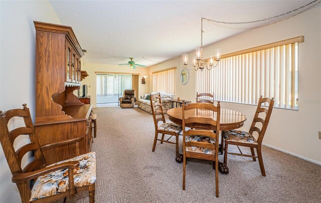 3838 Lanyard Ct Unit B, New Port Richey, FL 34652 - dining room featuring carpet flooring, a chandelier, a ceiling fan, and baseboards