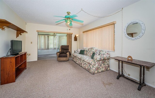 3838 Lanyard Ct Unit B, New Port Richey, FL 34652 - living room with a ceiling fan, carpet, and a textured ceiling