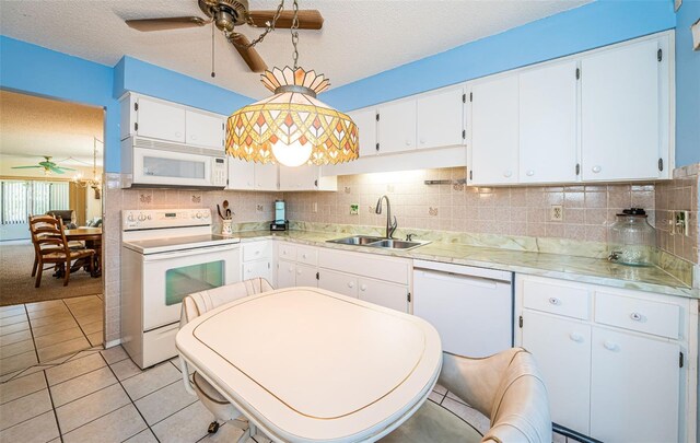 3838 Lanyard Ct Unit B, New Port Richey, FL 34652 - kitchen featuring white appliances, a ceiling fan, a sink, light countertops, and a textured ceiling