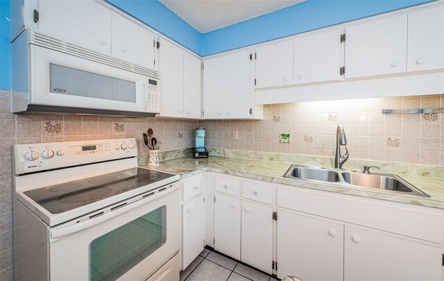 3838 Lanyard Ct Unit B, New Port Richey, FL 34652 - kitchen featuring white appliances, a sink, light countertops, white cabinetry, and a textured ceiling