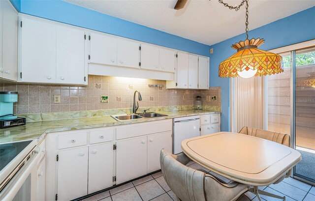 3838 Lanyard Ct Unit B, New Port Richey, FL 34652 - kitchen with dishwasher, a sink, light countertops, decorative backsplash, and light tile patterned floors
