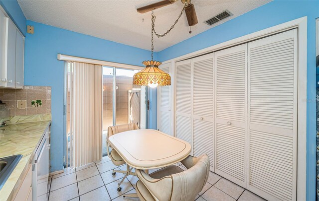 3838 Lanyard Ct Unit B, New Port Richey, FL 34652 - dining room with a ceiling fan, light tile patterned flooring, and a textured ceiling