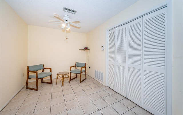 3838 Lanyard Ct Unit B, New Port Richey, FL 34652 - sitting room with ceiling fan, a textured ceiling, and light tile patterned flooring