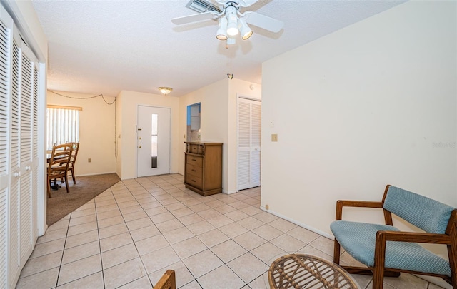 3838 Lanyard Ct Unit B, New Port Richey, FL 34652 - living area with a ceiling fan, light tile patterned flooring, and baseboards