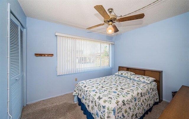 3838 Lanyard Ct Unit B, New Port Richey, FL 34652 - bedroom featuring a closet, carpet, a ceiling fan, baseboards, and a textured ceiling