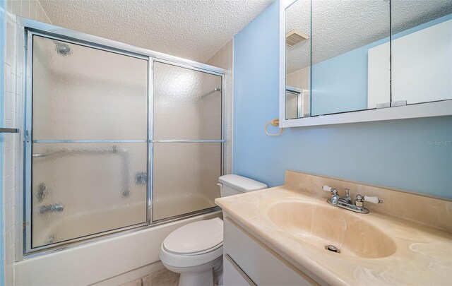 3838 Lanyard Ct Unit B, New Port Richey, FL 34652 - full bathroom with a textured ceiling, vanity, enclosed tub / shower combo, and toilet