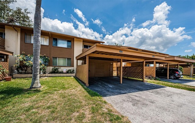 3838 Lanyard Ct Unit B, New Port Richey, FL 34652 - multi unit property with a front lawn, covered parking, and stucco siding