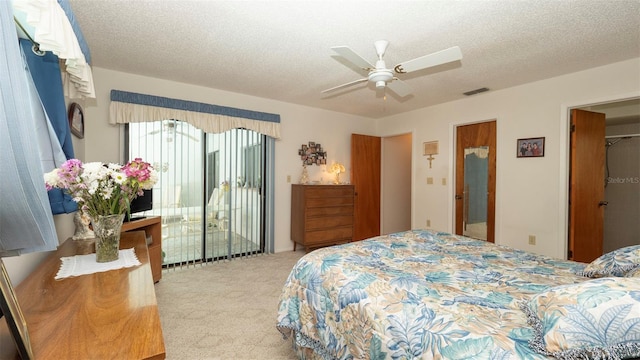 5309 Bayonne Ave, Spring Hill, FL 34608 - bedroom with light carpet, access to exterior, a textured ceiling, and a ceiling fan