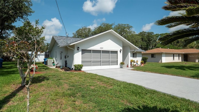 5309 Bayonne Ave, Spring Hill, FL 34608 - view of front facade with a garage, stucco siding, a front lawn, concrete driveway, and central AC unit