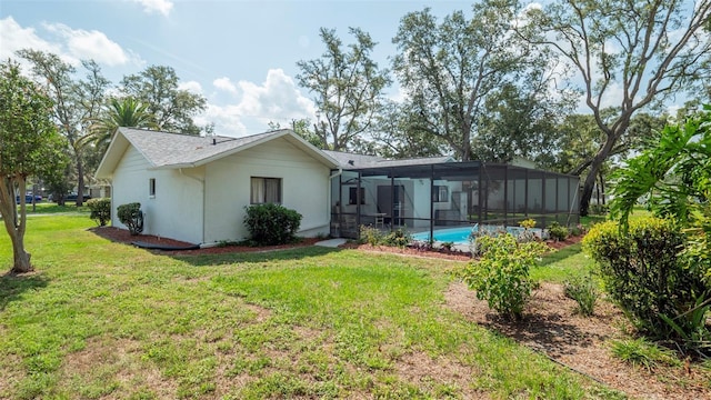 5309 Bayonne Ave, Spring Hill, FL 34608 - rear view of property featuring a yard, stucco siding, a lanai, and an outdoor pool