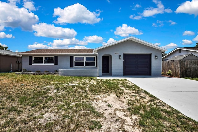 6306 Aberdeen Ave, New Port Richey, FL 34653 - ranch-style house with driveway, a garage, and brick siding