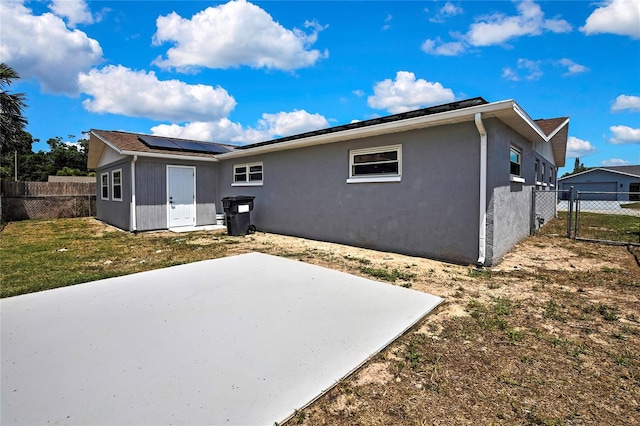 6306 Aberdeen Ave, New Port Richey, FL 34653 - back of house with solar panels, a patio, and stucco siding
