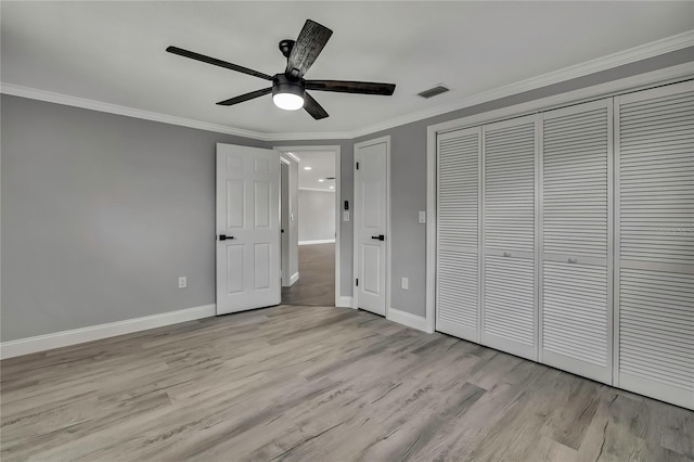 6306 Aberdeen Ave, New Port Richey, FL 34653 - unfurnished bedroom with wood finished floors, ornamental molding, baseboards, a closet, and a ceiling fan