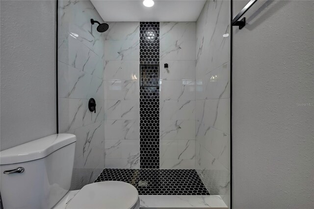 6306 Aberdeen Ave, New Port Richey, FL 34653 - bathroom with toilet, a tile shower, and a textured wall