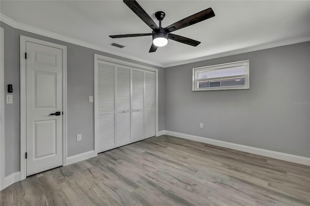 6306 Aberdeen Ave, New Port Richey, FL 34653 - unfurnished bedroom with baseboards, ornamental molding, a closet, wood finished floors, and ceiling fan