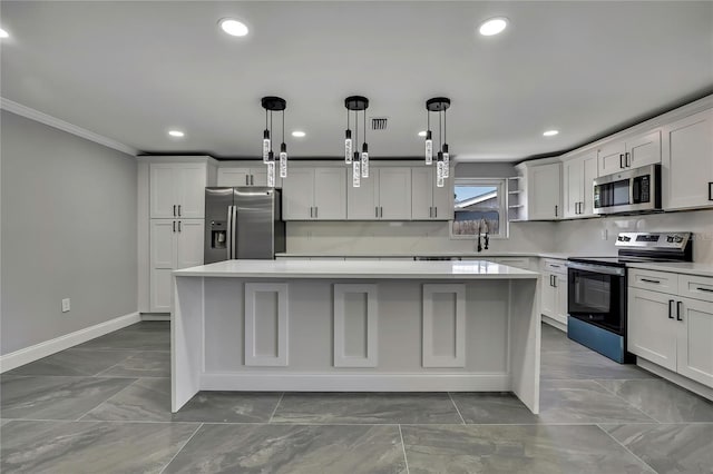 6306 Aberdeen Ave, New Port Richey, FL 34653 - kitchen featuring stainless steel appliances, a center island, ornamental molding, light countertops, and baseboards