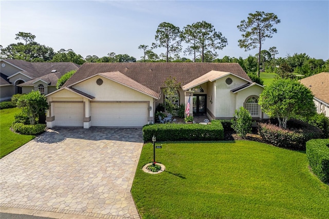 8132 Summersong Ct, Spring Hill, FL 34606 - ranch-style house featuring stucco siding, decorative driveway, a garage, a front lawn, and roof with shingles