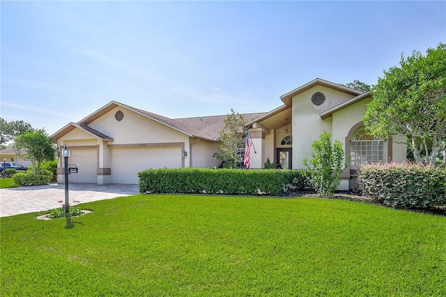 8132 Summersong Ct, Spring Hill, FL 34606 - view of front of home with stucco siding, a front yard, driveway, and a garage