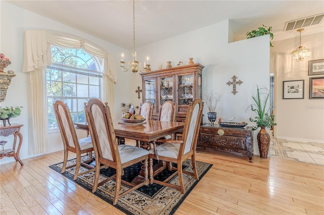 8132 Summersong Ct, Spring Hill, FL 34606 - dining area featuring a chandelier, light wood-style floors, and baseboards