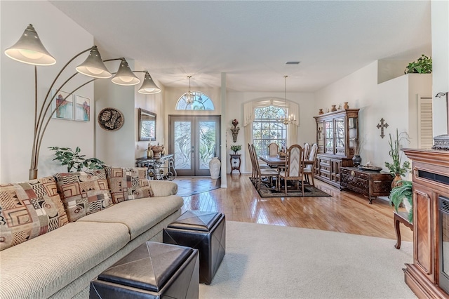 8132 Summersong Ct, Spring Hill, FL 34606 - living area with a chandelier, hardwood / wood-style flooring, french doors, and carpet floors