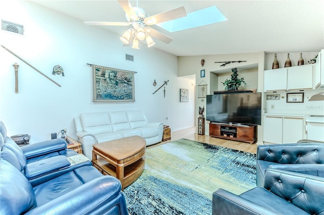 8132 Summersong Ct, Spring Hill, FL 34606 - living area with vaulted ceiling, ceiling fan, a skylight, light wood-style floors, and baseboards