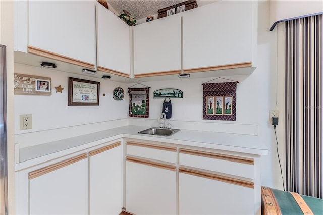 8132 Summersong Ct, Spring Hill, FL 34606 - kitchen featuring light countertops, a sink, white cabinets, and a textured ceiling