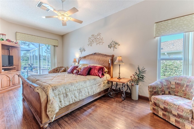 8132 Summersong Ct, Spring Hill, FL 34606 - bedroom featuring access to exterior, light wood finished floors, a textured ceiling, ceiling fan, and baseboards
