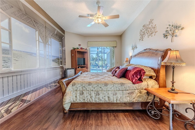 8132 Summersong Ct, Spring Hill, FL 34606 - bedroom featuring wood finished floors, a textured ceiling, a ceiling fan, and access to outside
