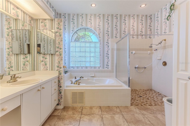 8132 Summersong Ct, Spring Hill, FL 34606 - bathroom with vanity, a garden tub, tiled shower, wallpapered walls, and recessed lighting