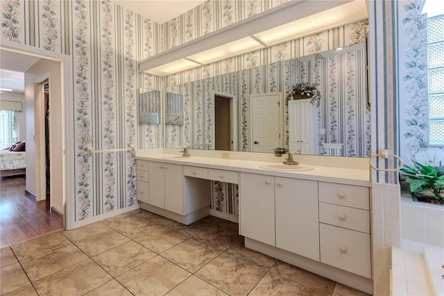 8132 Summersong Ct, Spring Hill, FL 34606 - ensuite bathroom with double vanity, wallpapered walls, tile patterned floors, baseboards, and a tub