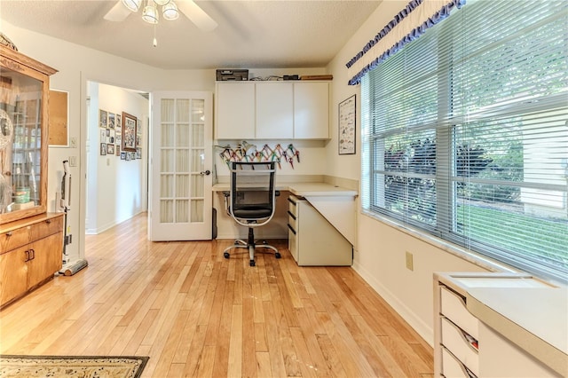 8132 Summersong Ct, Spring Hill, FL 34606 - office space featuring a ceiling fan, built in study area, light wood-style flooring, baseboards, and a textured ceiling