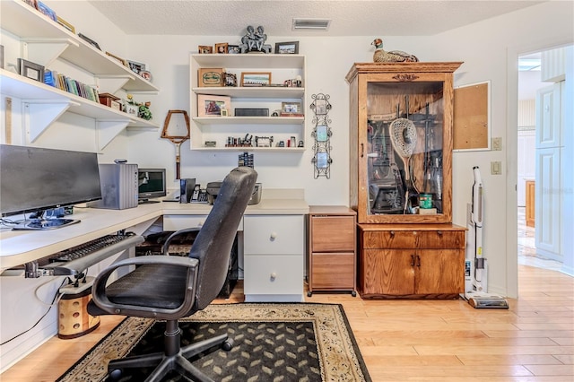 8132 Summersong Ct, Spring Hill, FL 34606 - home office with light wood-style floors and a textured ceiling