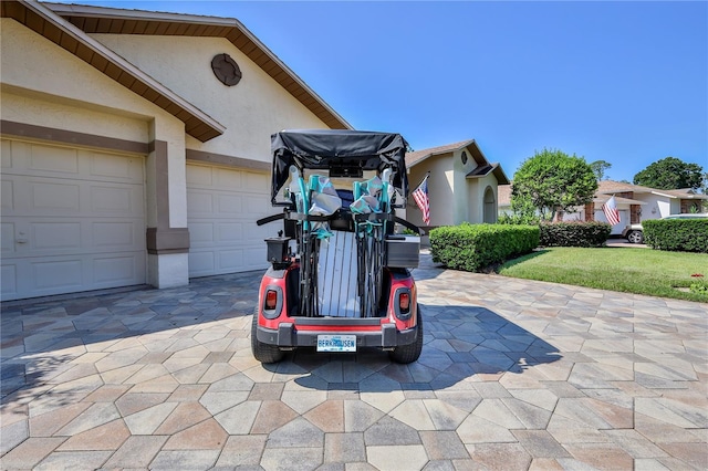 8132 Summersong Ct, Spring Hill, FL 34606 - view of patio featuring decorative driveway and a garage